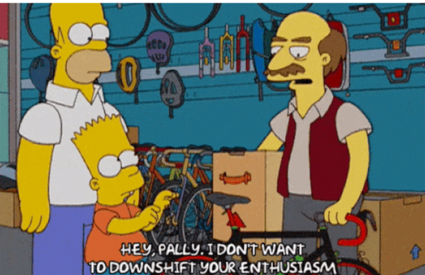 Homer and Bart Simpson are in a bike shop talking to a bald, moustachioed employee pulling a bike away from Bart. The employee says, "Hey, Pally, I don't want to downshift your enthusiasm."